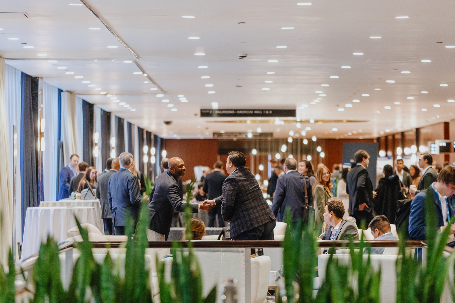 People gathering in conference reception area
