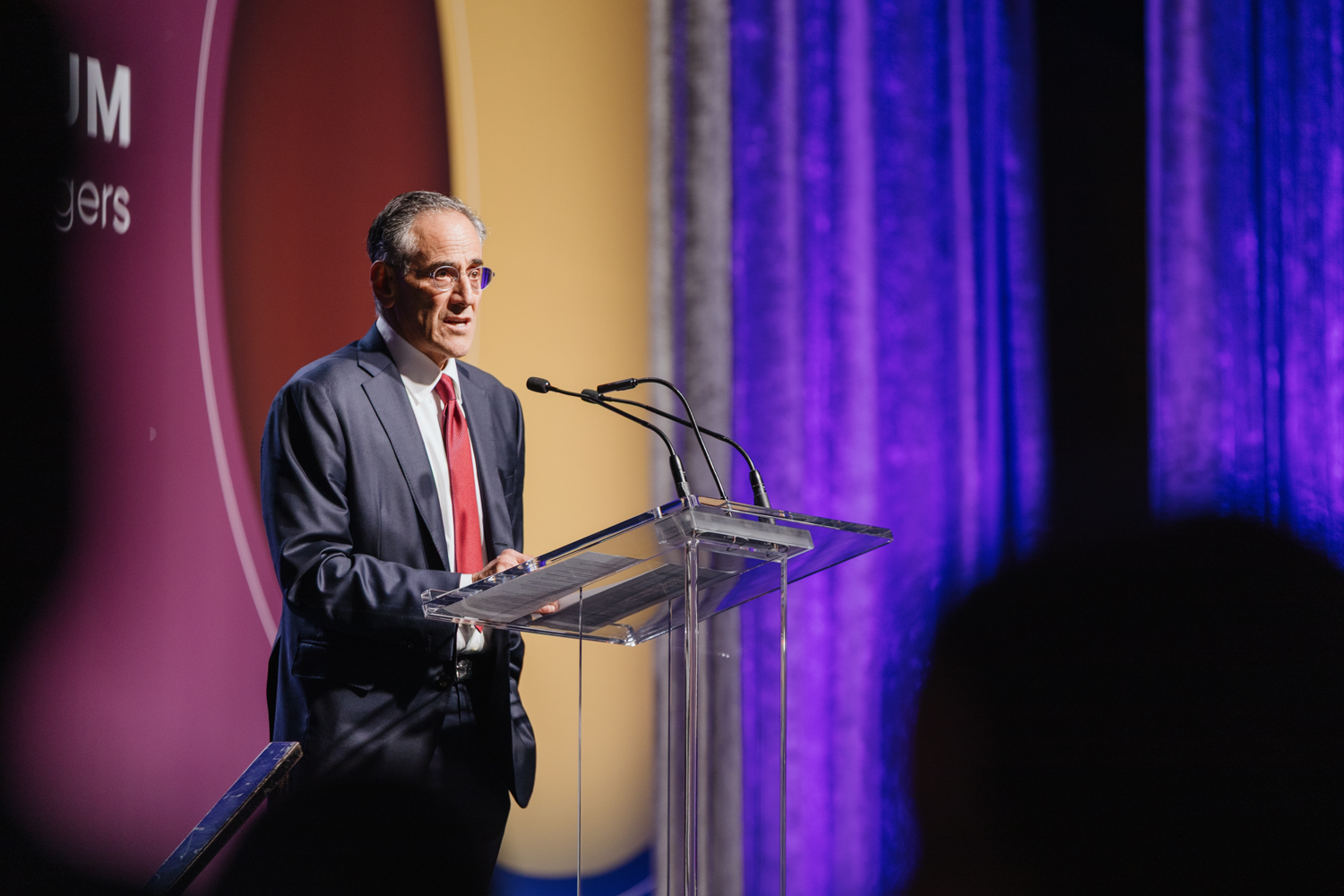 Michael Sacks speaking on stage at SEM Consortium 2025